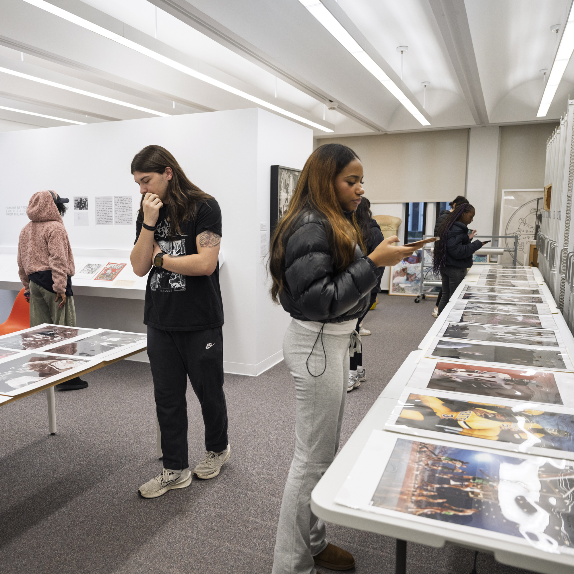 Two university students are browsing through the online database on the two research computers in the Collections Study Space. 